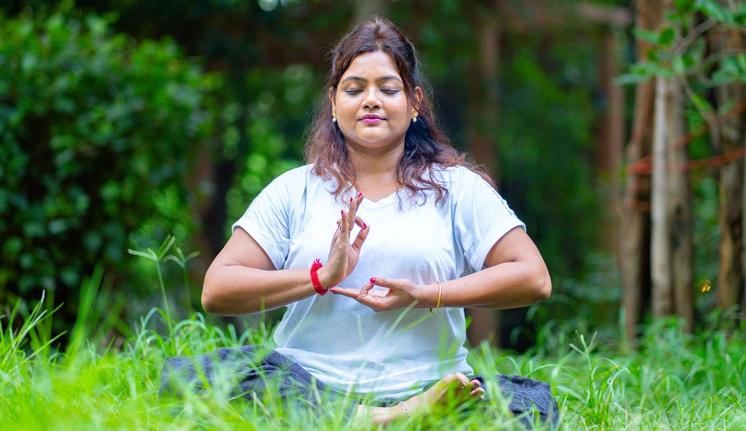 A serene practitioner performing Trataka Meditation with candle gazing at Nabatara Foundation.